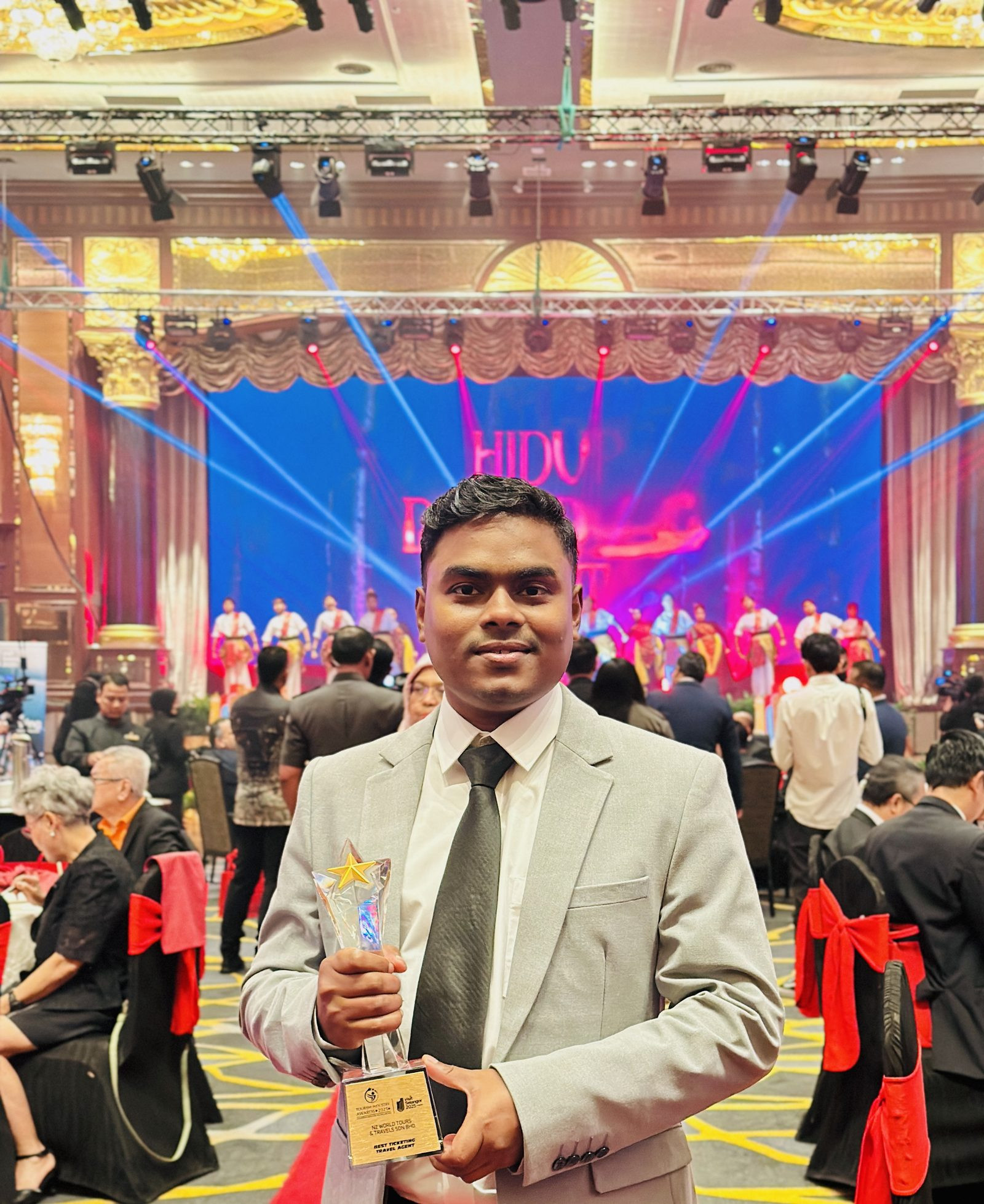 M Fazla Rabby holding the Best Ticketing Travel Agent trophy awarded to NZ World Tours & Travels at the Tourism Industry Awards 2025